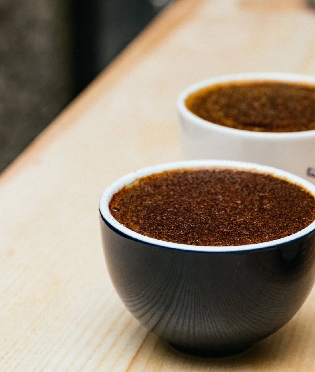 Deux cafés aux arômes intenses dans une tasse noire et une tasse blanche